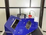 a blue machine that is sitting on top of a table