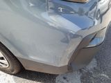 a close up of a car ' s front bumper with a denting on it