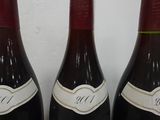 three bottles of wine that are sitting on a table