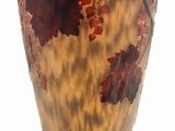 a vase that has a bird on a branch on it
