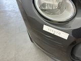 a close up of a car ' s headlight with a sticker on it