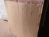a cardboard box sitting on the floor in front of a wall