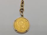 a close up of a coin on a chain on a table