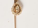 a close up of a pair of earrings on a white surface