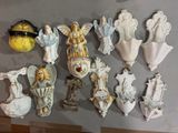 many figurines of angels and angels on the wall