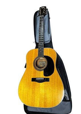 an acoustic guitar with a case on top of it