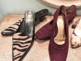 several pairs of shoes are lined up on a table in front of a mirror