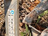 a metal pole with a sticker on it sitting on the ground