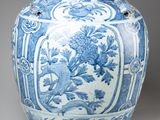 blue and white vase with flowers and birds on it