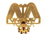 an image of a gold broochle with a bird on top of it