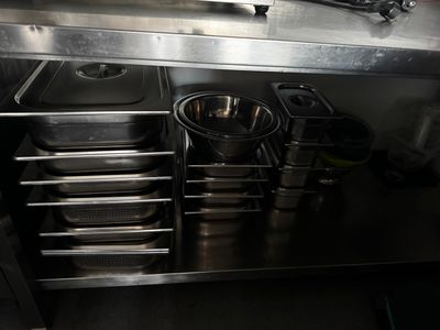 stainless steel counter top with pans and pans on it