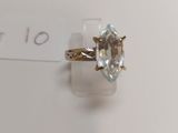a close up of a gold ring with a blue topaz stone