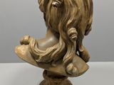 an image of a busturine of a woman with long hair on a pedestal