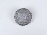 a close up of a coin on a white surface with a white background