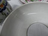 a close up of a bowl and a cup on a table
