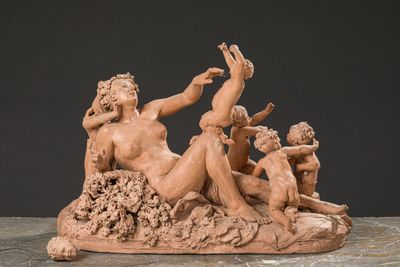 statue of a group of nudes sitting on a rock