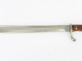 a close up of a knife with a wooden handle on a white surface
