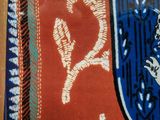 a picture of a coat of arms on a red and blue cloth