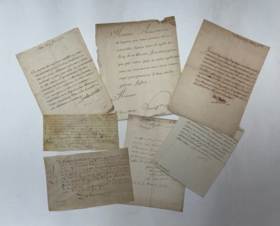 a bunch of old letters and papers sitting on top of a table