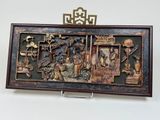 an image of a wooden plaque with a picture of people and animals on it