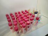 many bottles of lotion sitting on a counter