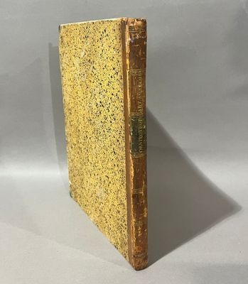 a close up of a book on a table with a white background