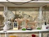 a shelf that has many different glass items on it