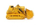 a yellow toy bulldozer sitting on a white surface