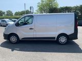 the white van is parked in a parking lot with other cars