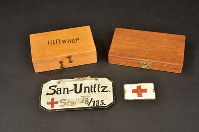 two small wooden boxes and a small wooden box with a red cross on it
