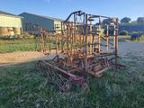 a tractor that is sitting in the grass near a building