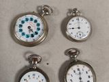 four different types of pocket watches sitting on top of a table
