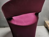 a purple chair that is sitting in the corner of a room