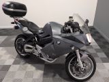 a motorcycle that is parked on a checkered floor