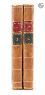 two old books sitting on top of each other on a white surface