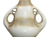 a white vase with holes in it on a white background