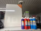 de nombreuses couleurs de peinture différentes sur une étagère dans un magasin