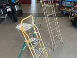 two ladders that are sitting in the middle of a room