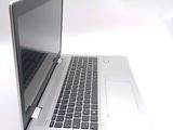 a silver laptop computer sitting on a white surface