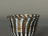 a black and white bowl with blue dots on it