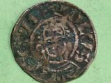 an old coin sitting on top of a green surface