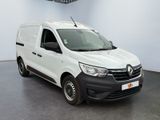 the white van is parked in a large room with a black floor