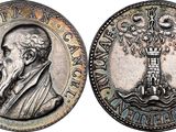 a close up of a coin with an image of a man holding a cross