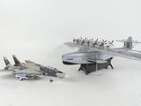 two model airplanes sitting next to each other on a white surface