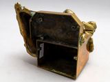 bronze figurine of a man holding a box on a white surface