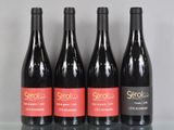 trois bouteilles de vin rouge sont alignées sur une table