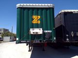 a large green container sitting on the back of a truck