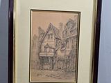drawing of a house in a frame on a table