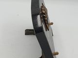 a metal object with a bug on it on a white surface