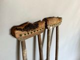 two old wooden crutches that are leaning against a wall